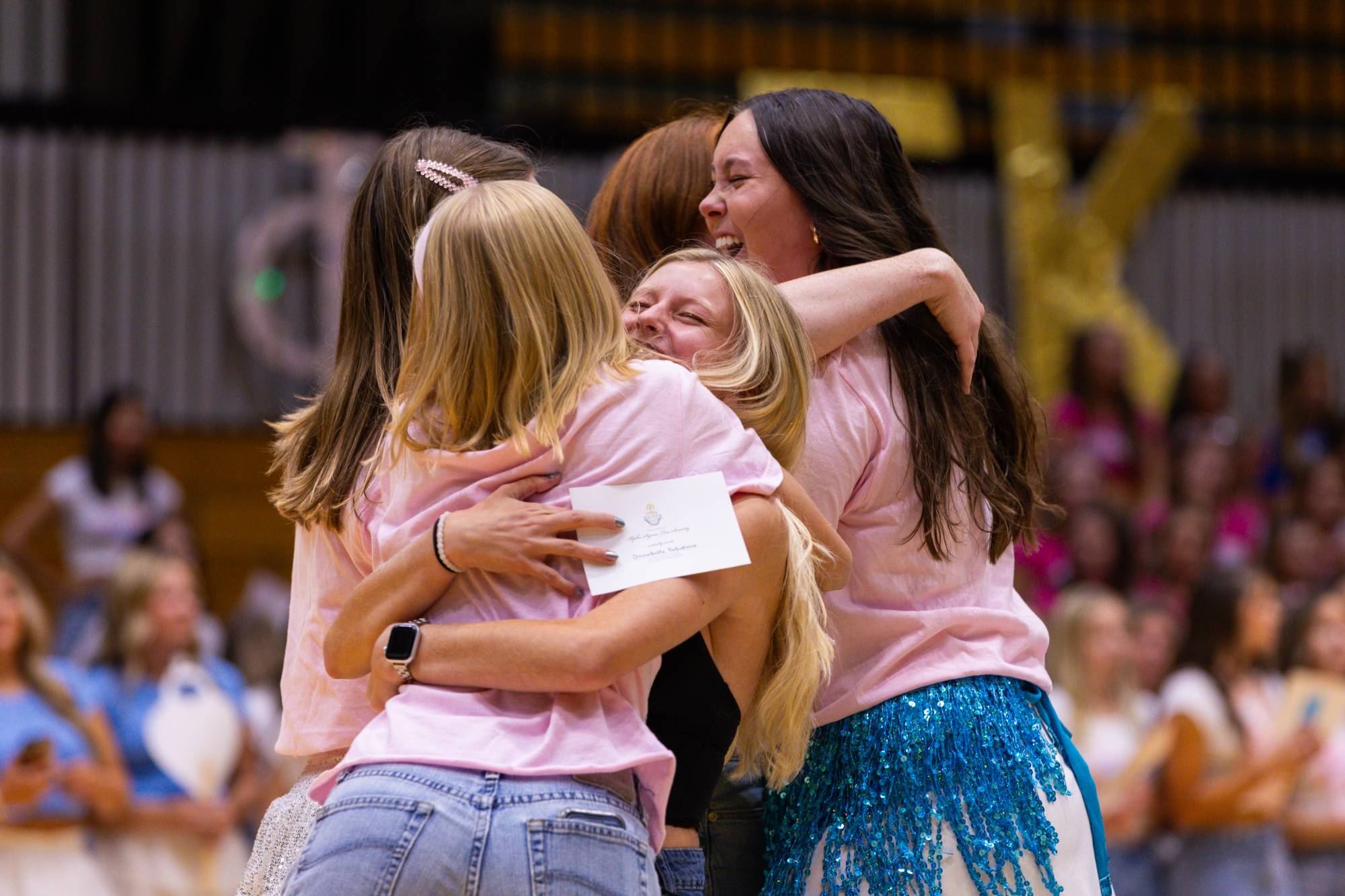 students embracing after receiving an invitation to join a sorority